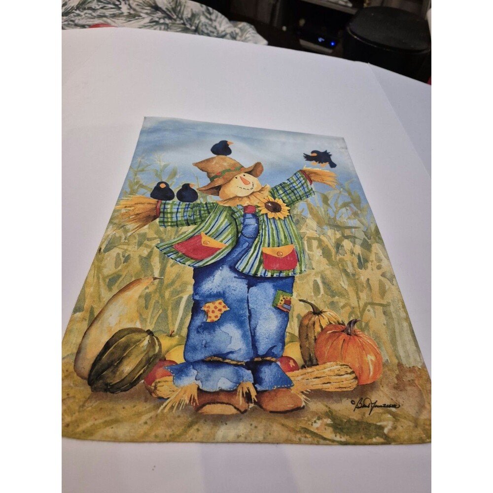 scarecrow in a pumpkin patch with black birds. 12x18 Garden Flag